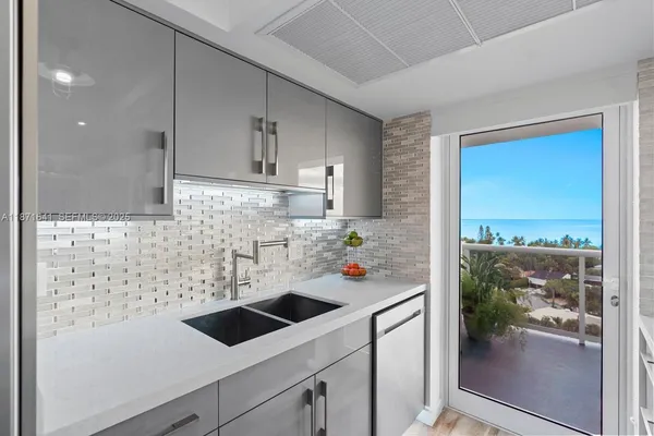 a view of a kitchen with a sink and refrigerator