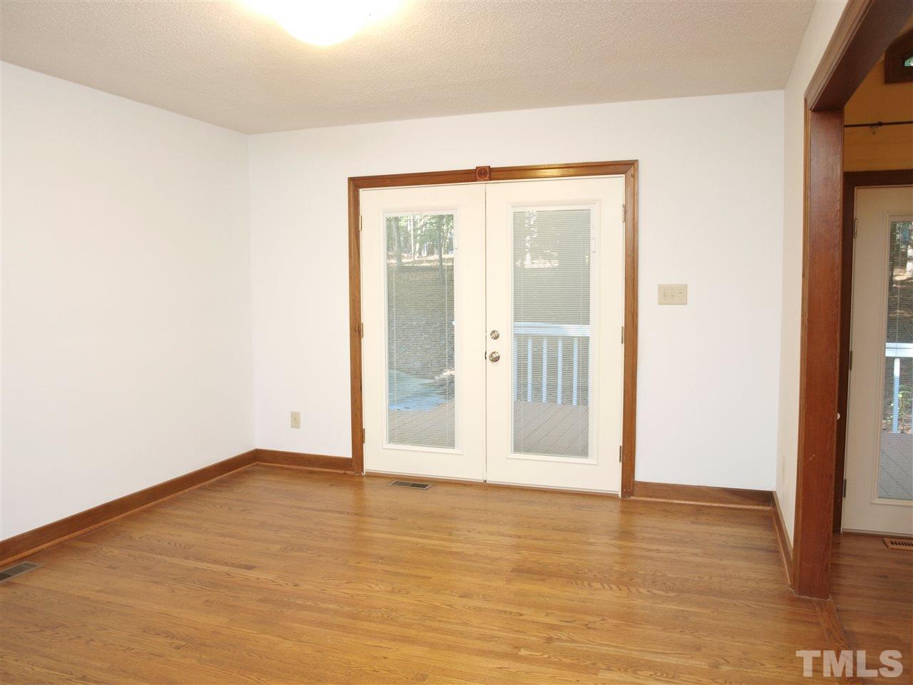 11013 Coachmans Way Raleigh, NC 27614 - Photo 3 of 15 a view of an empty room with wooden floor and a window