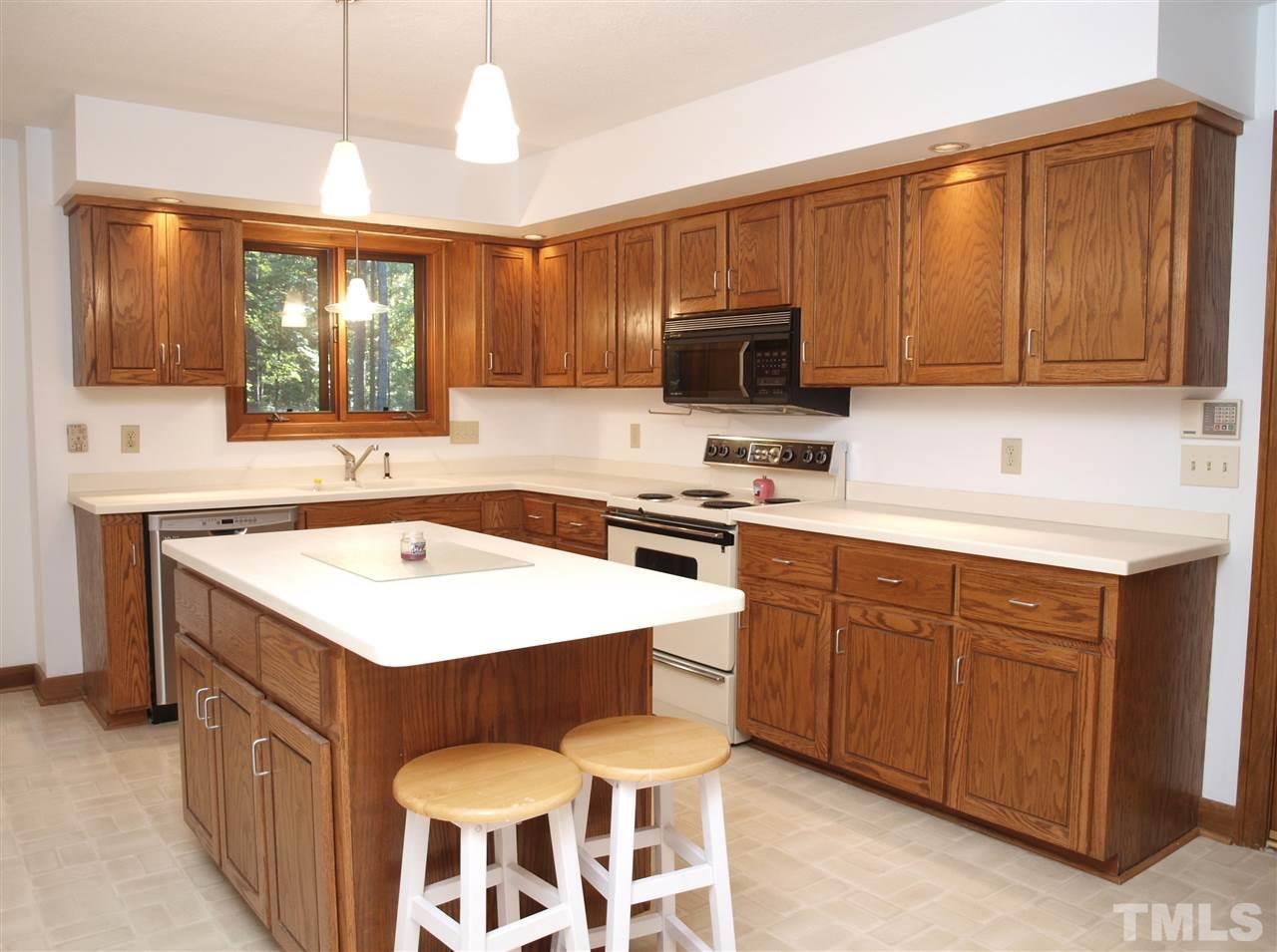 11013 Coachmans Way Raleigh, NC 27614 - Photo 4 of 15 a kitchen with a stove a sink and a refrigerator