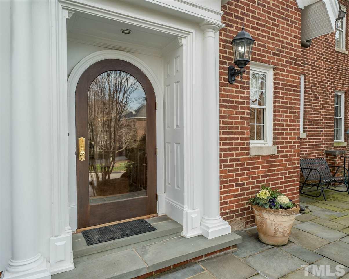 405 Dekoven Place Raleigh, NC 27608 - Photo 2 of 25 Solid mahogany custom door with glass storm door, matching the original arch on the house above.