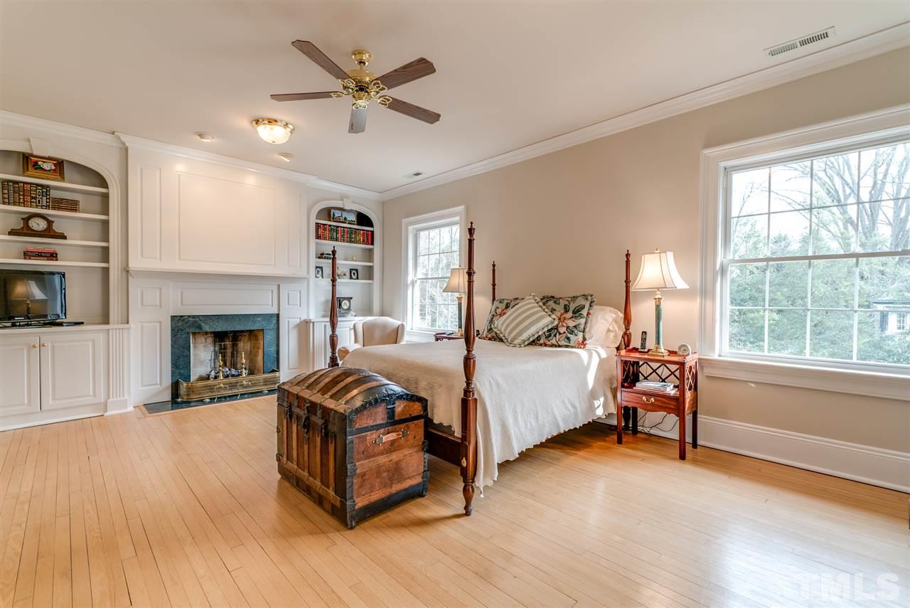405 Dekoven Place Raleigh, NC 27608 - Photo 15 of 25 Spacious master bedroom with built in bookcase and cozy fireplace