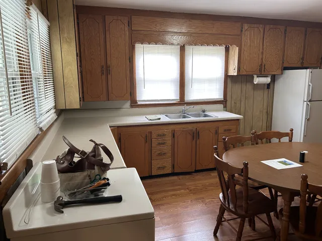a kitchen with a stove a sink and a refrigerator