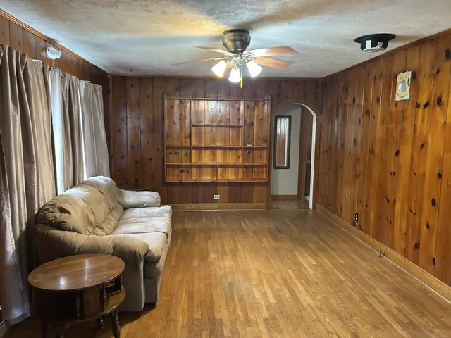 a living room with furniture and a chandelier