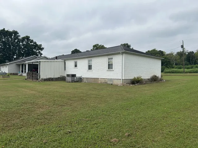 a white house that has a tree in front of it