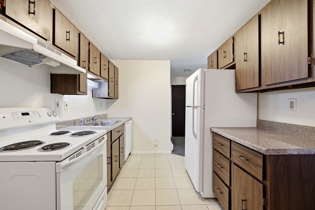 80 Damon Road, Unit 2303 Northampton, MA 01060 - Photo 13 of 23 a kitchen with stainless steel appliances a stove microwave and a refrigerator