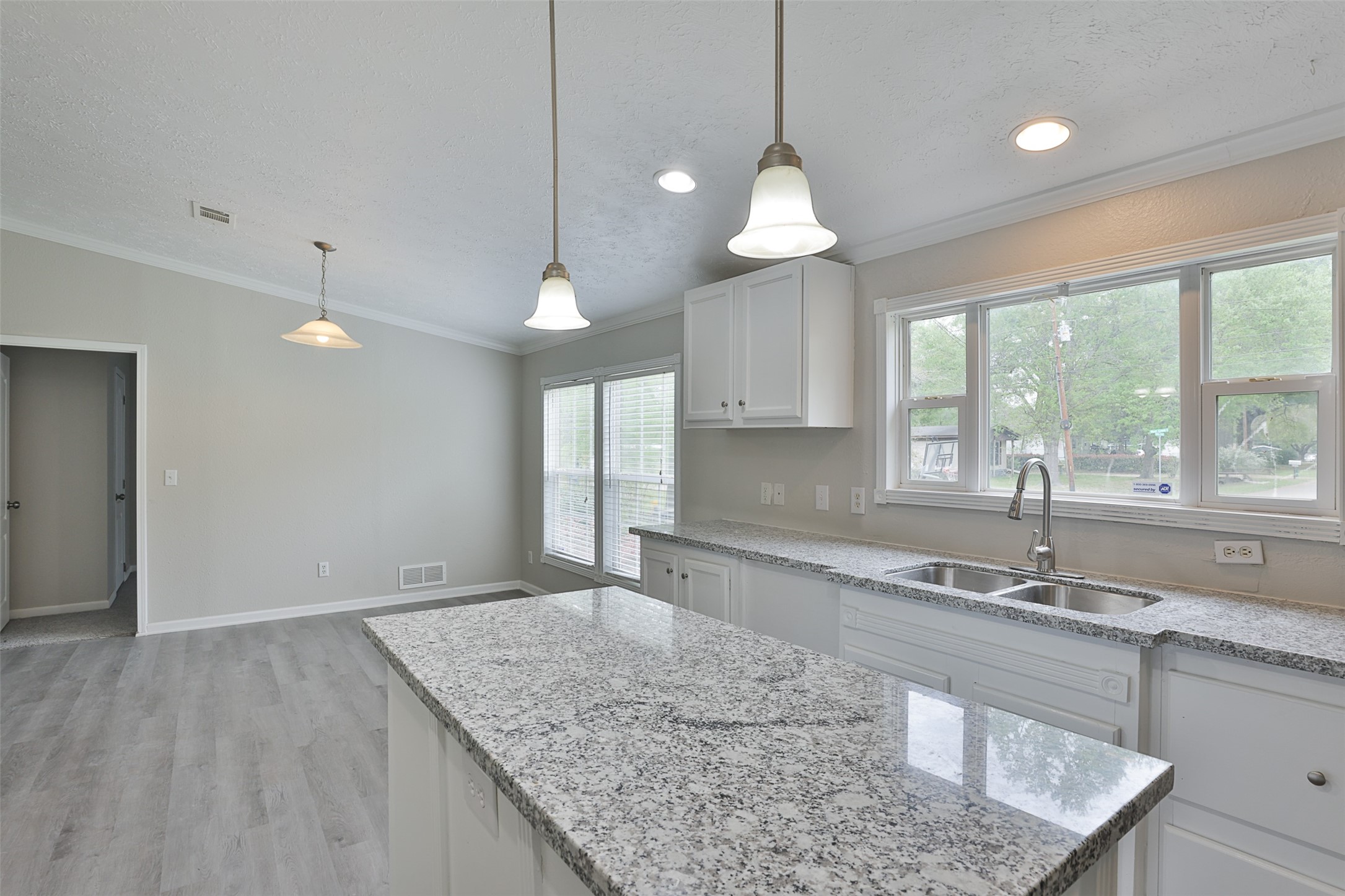 1520 West Creek Drive Conroe, TX 77304 - Photo 12 of 29 a kitchen with granite countertop a sink a center island a counter space and a window