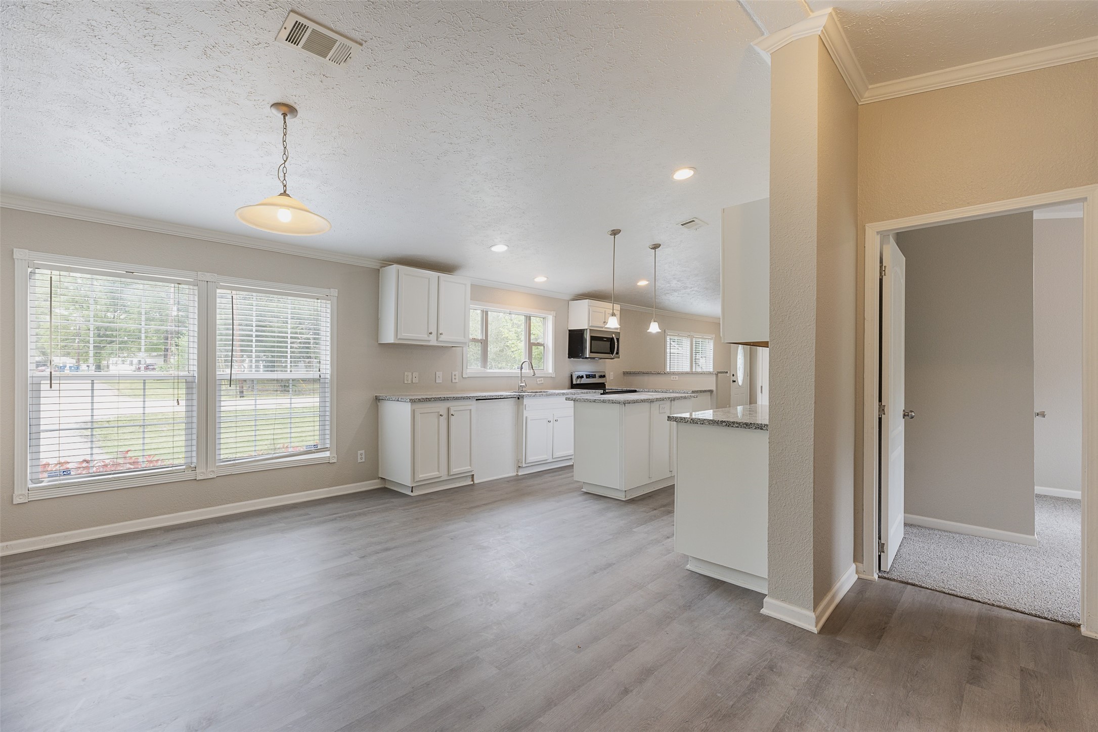 1520 West Creek Drive Conroe, TX 77304 - Photo 13 of 29 a view of a kitchen with a sink and dishwasher a refrigerator with wooden floor