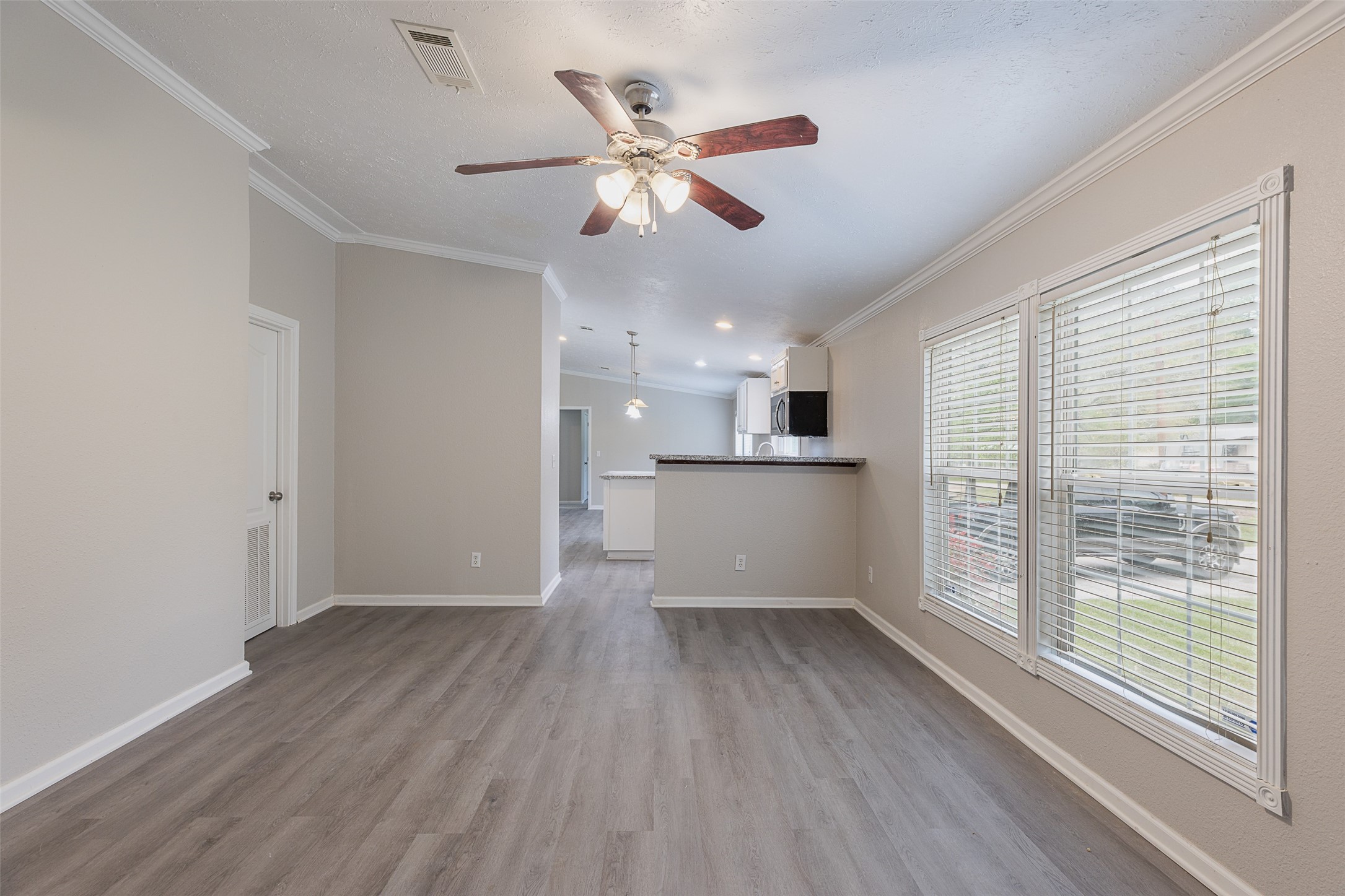 1520 West Creek Drive Conroe, TX 77304 - Photo 2 of 29 a view of an empty room with wooden floor and a window