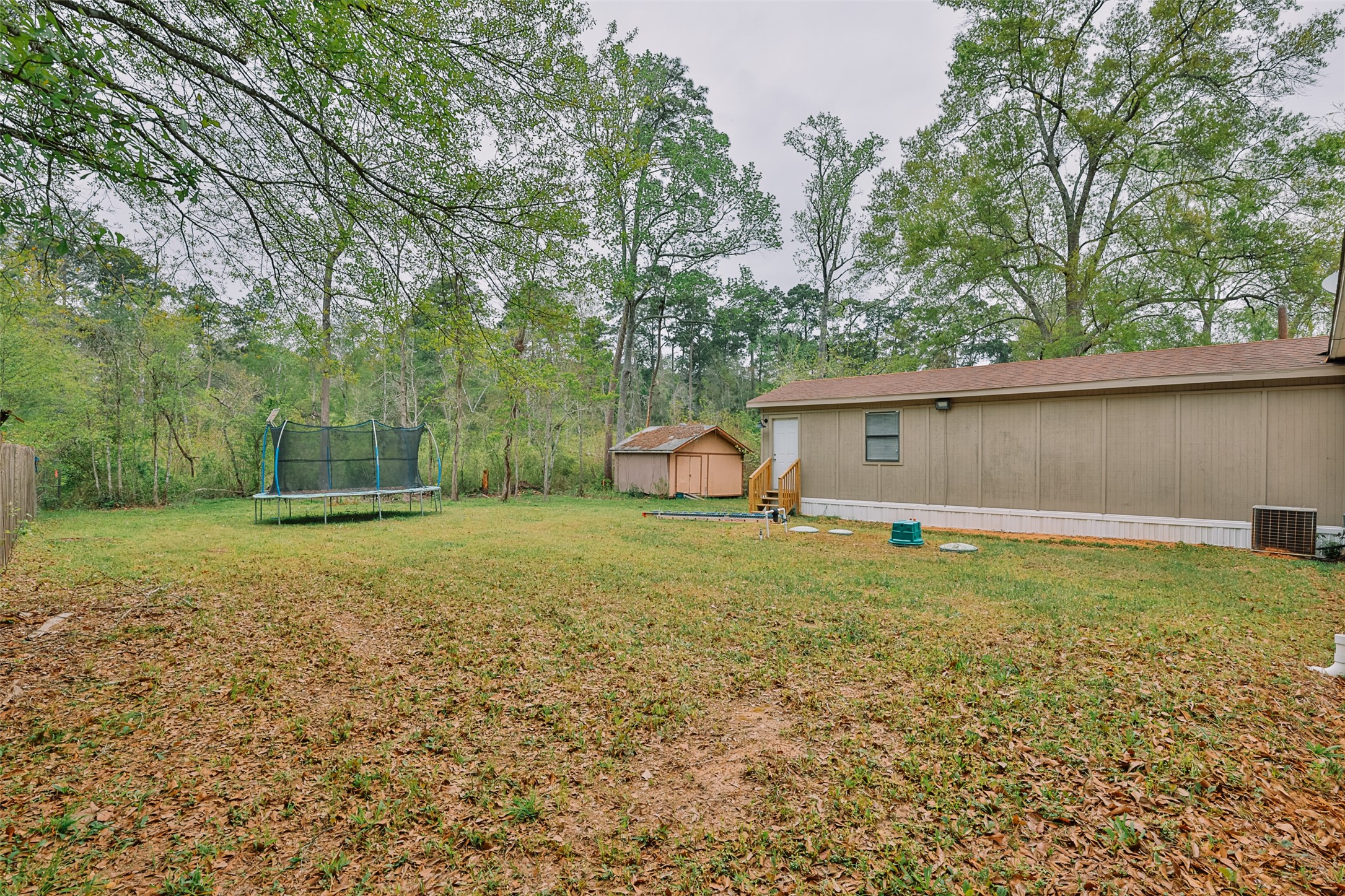 1520 West Creek Drive Conroe, TX 77304 - Photo 26 of 29 a backyard of a house with lots of green space