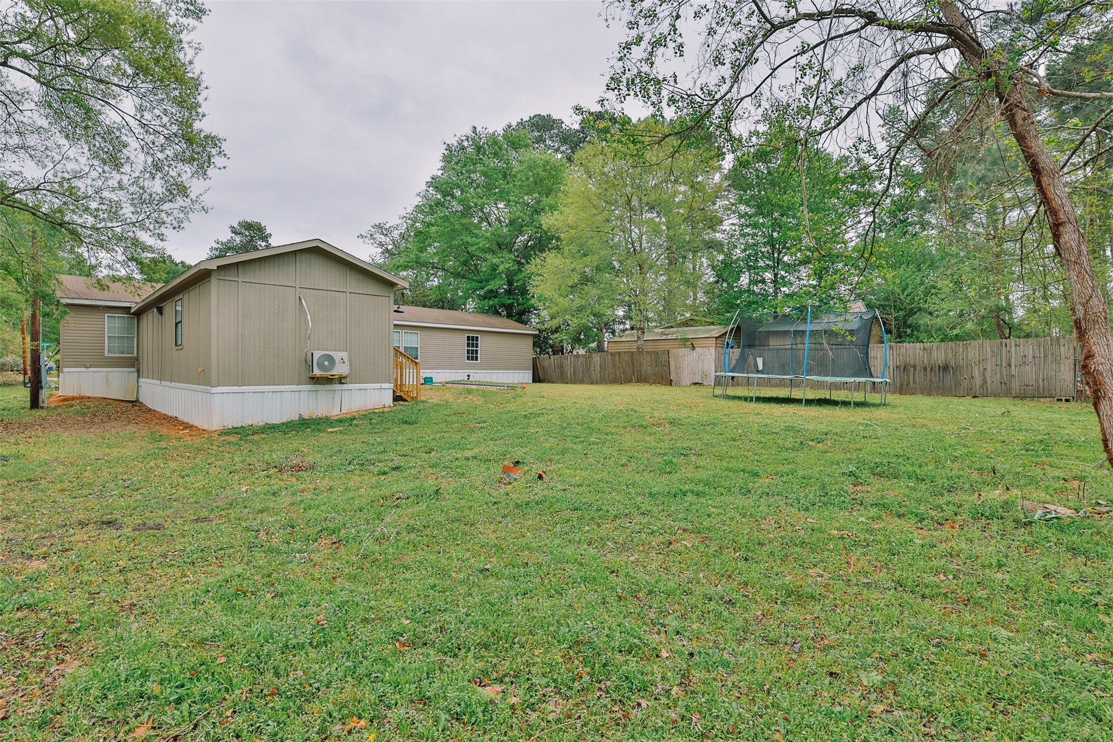 1520 West Creek Drive Conroe, TX 77304 - Photo 27 of 29 a white house that has a tree in front of it