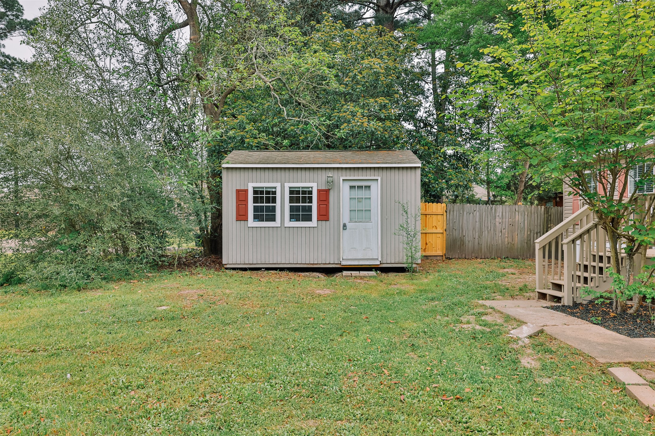1520 West Creek Drive Conroe, TX 77304 - Photo 28 of 29 a view of a house with backyard and a tree