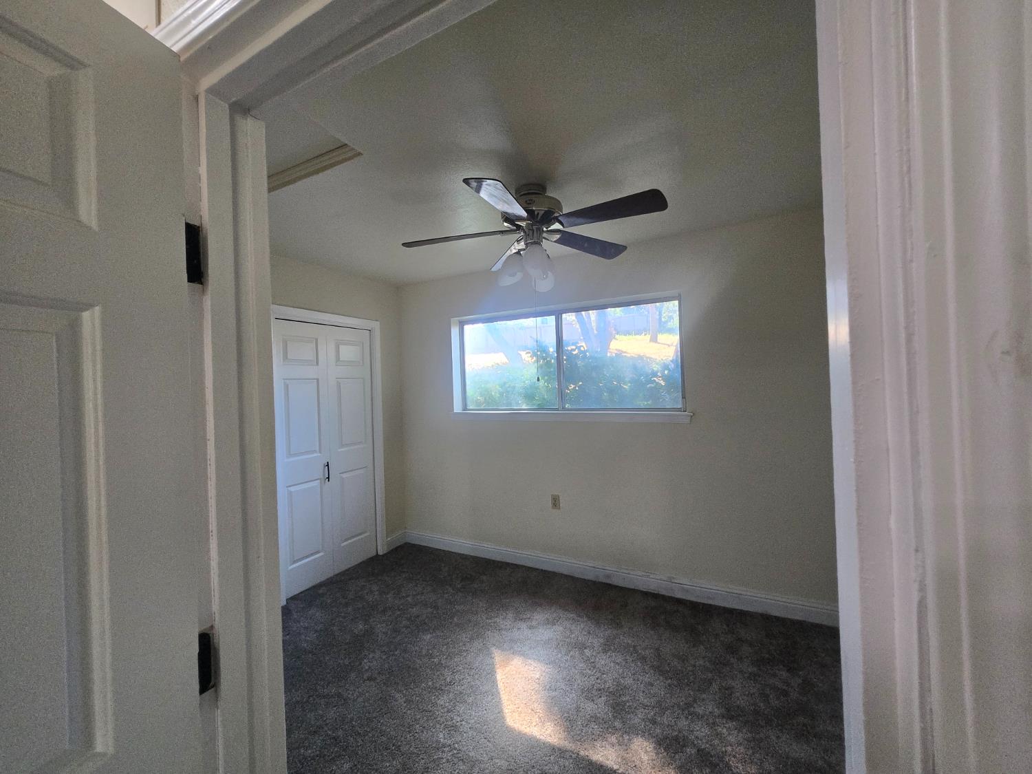 10601 Lime Kiln Road Grass Valley, CA 95949 - Photo 22 of 79 First bedroom right off of the kitchen. Ceiling fan helps keep the room comfortable all seasons long.