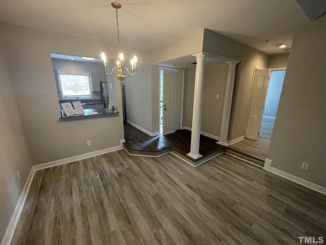 a view of a room with wooden floor and window