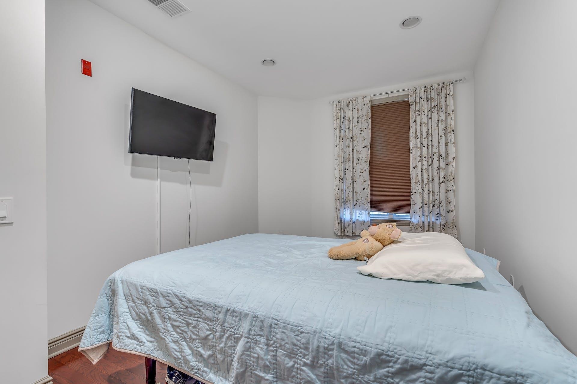 7400 River Road, Unit 315 North Bergen, NJ 07047 - Photo 11 of 19 a bedroom with a bed and a flat screen tv