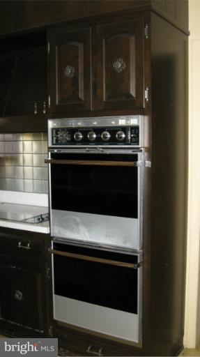 13105 Bottom Road Hydes, MD 21082 - Photo 13 of 22 a stove top oven sitting inside of a kitchen