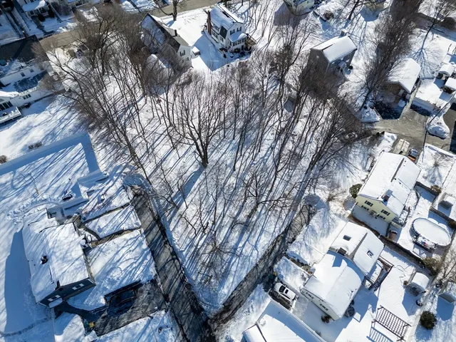 a backyard of a building with large trees