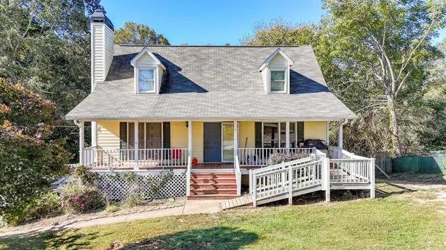 an aerial view of a house with a yard and balcony