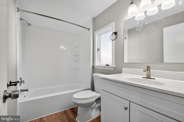 a bathroom with a sink a toilet and a bathtub