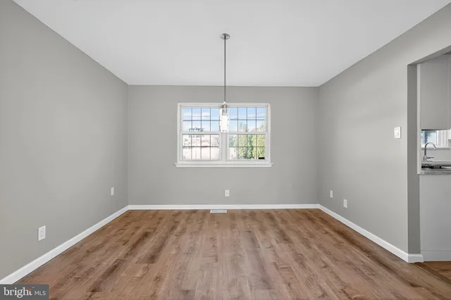 a view of room with window wooden floor and ceiling fan