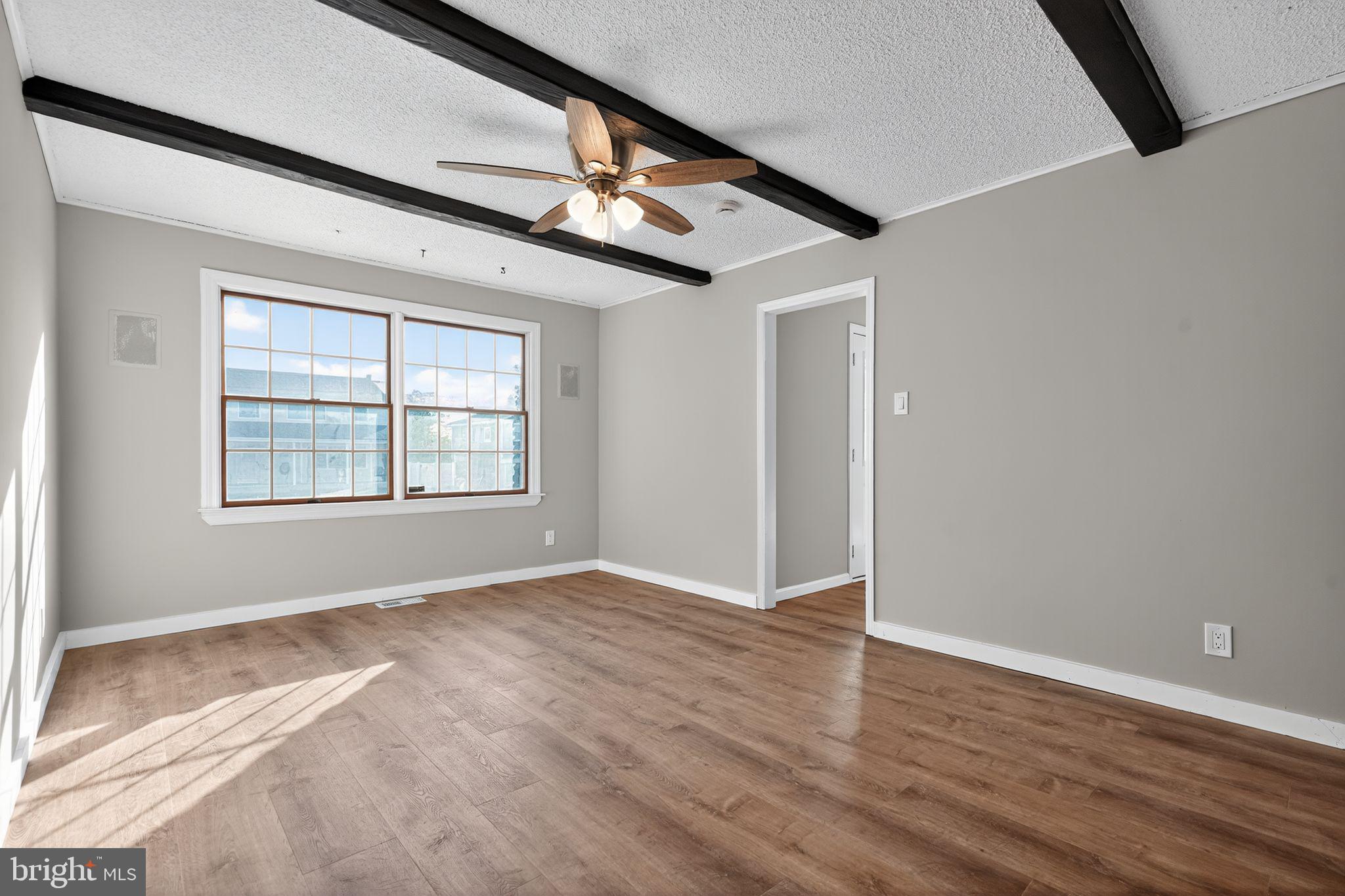 14 Benner Road Blackwood, NJ 08012 - Photo 25 of 32 an empty room with wooden floor chandelier and windows