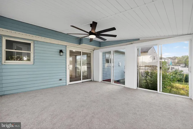a view of a livingroom with a ceiling fan and window
