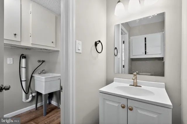 a bathroom with a sink a toilet and mirror