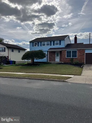 a view of a house with a garden and pathway
