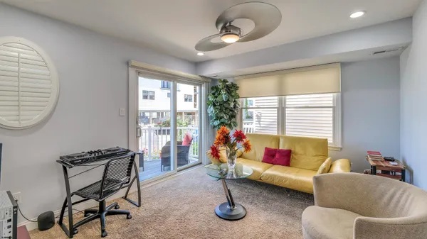 a view of a livingroom with furniture wooden floor and windows