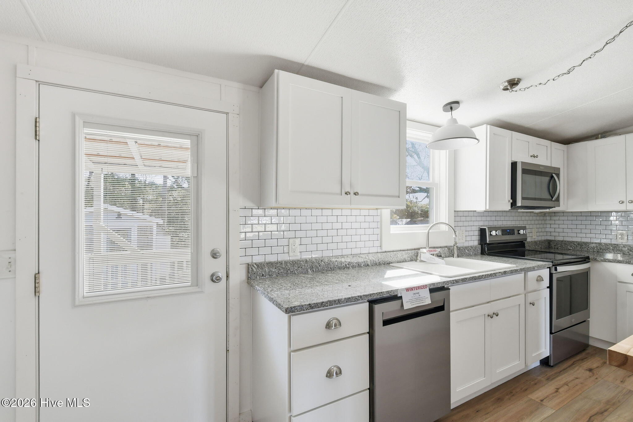 2228 Harbor Ridge Drive Southeast Bolivia, NC 28422 - Photo 12 of 30 Kitchen entrance/ exit onto the backyard Deck