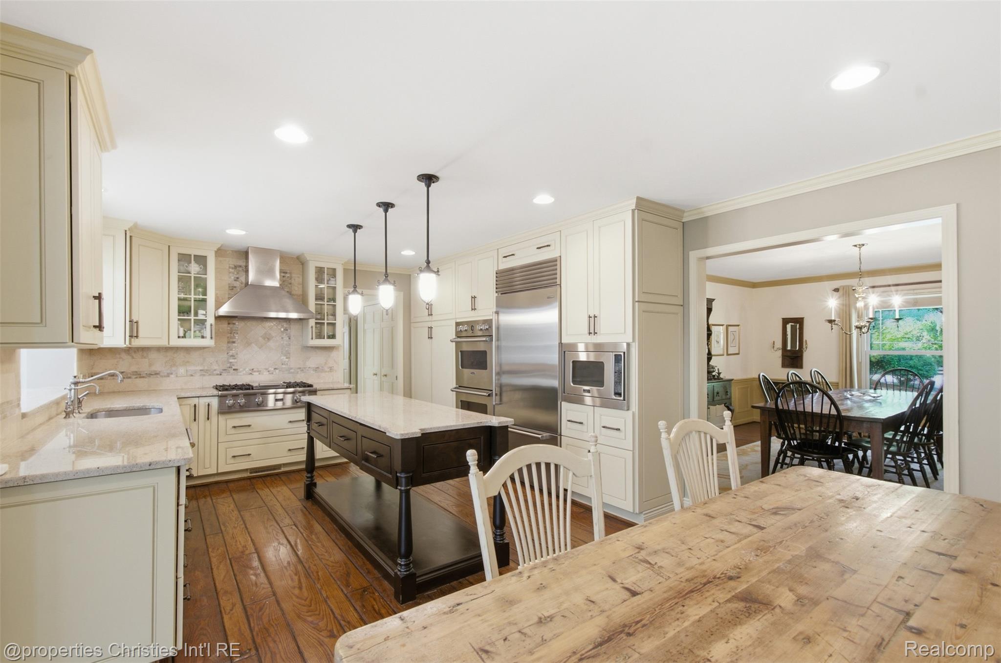 25235 Canterbury Road Franklin, MI 48025 - Photo 16 of 56 Gourmet kitchen featuring a central island with countertop, stainless steel appliances, recessed lighting, and wood flooring. Looking into Dining Room