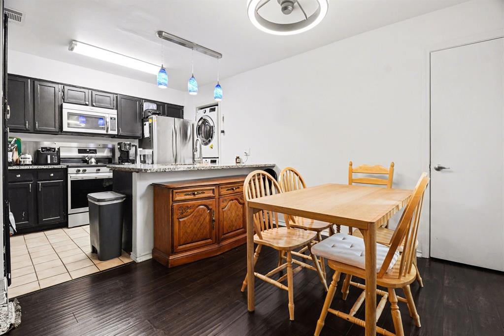 5616 Preston Oaks Road, Unit 102 Dallas, TX 75254 - Photo 5 of 11 a kitchen with a table chairs refrigerator and cabinets