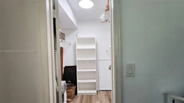 a view of a kitchen with a sink and a refrigerator
