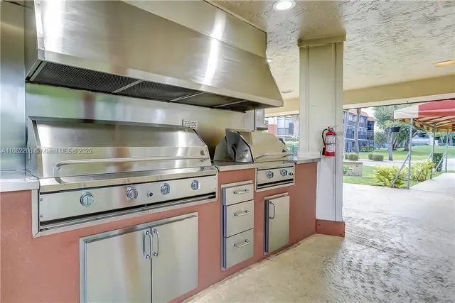 a view of a house with a yard and tree s