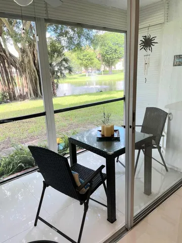 a view of a dining room with furniture and window