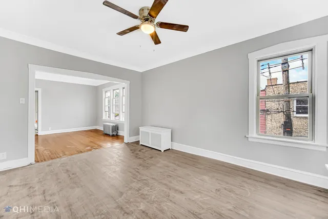 a view of an empty room with wooden floor