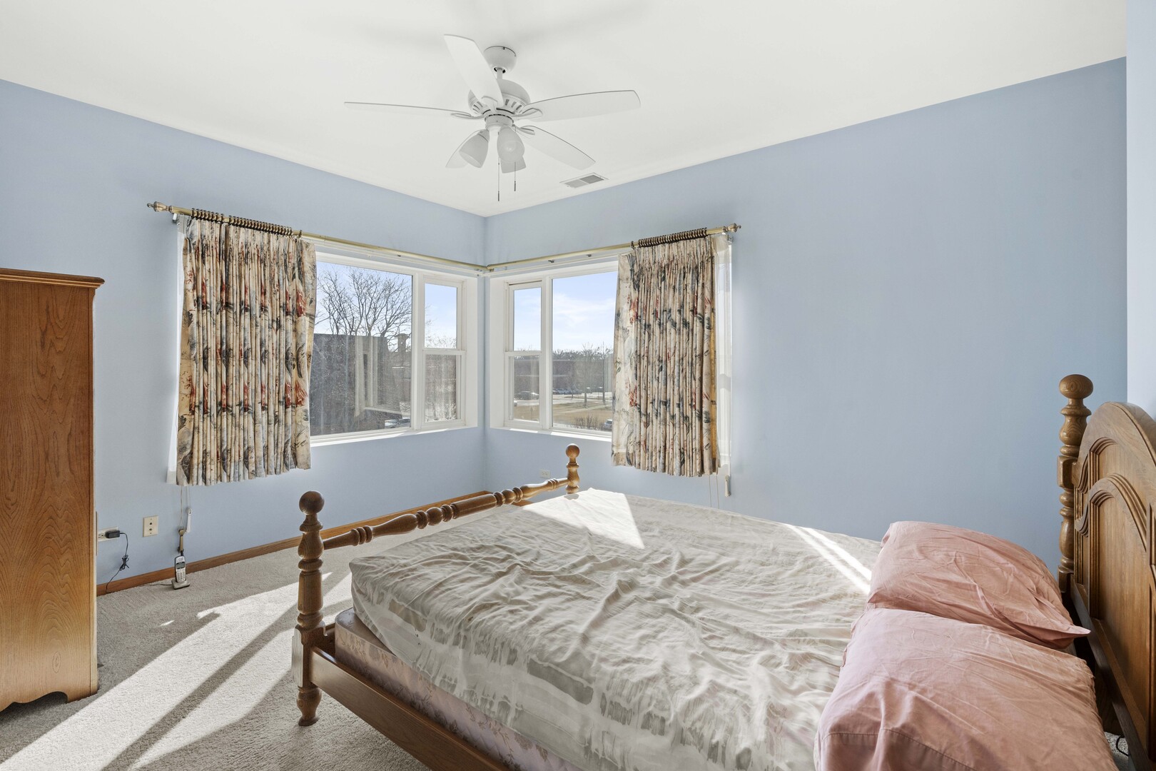 18134 Martin Avenue Homewood, IL 60430 - Photo 18 of 29 a bedroom with a large bed and a chandelier