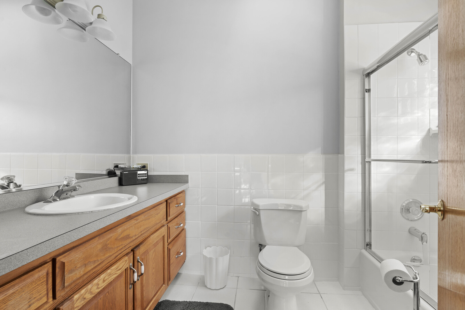 18134 Martin Avenue Homewood, IL 60430 - Photo 20 of 29 a bathroom with a granite countertop sink a toilet and a mirror