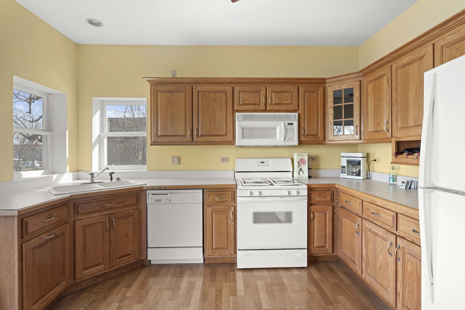18134 Martin Avenue Homewood, IL 60430 - Photo 6 of 29 a kitchen with stainless steel appliances granite countertop a stove top oven a sink dishwasher and white cabinets with wooden floor