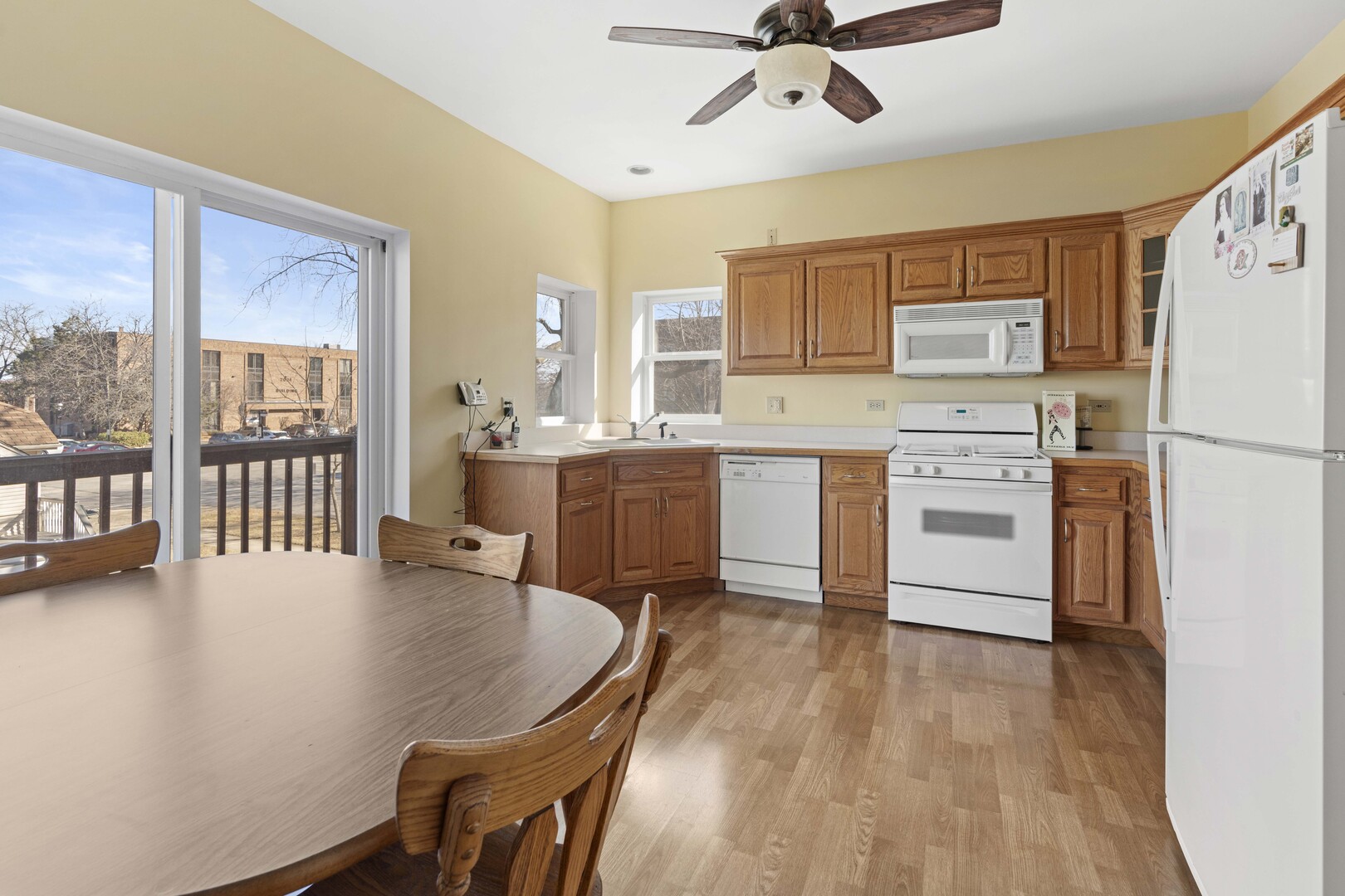 18134 Martin Avenue Homewood, IL 60430 - Photo 7 of 29 a kitchen with a table chairs refrigerator and cabinets