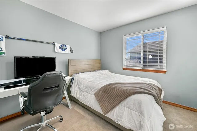 a bedroom with a bed and chair