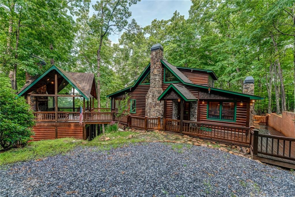 971 Scenic Mountain View Road Blue Ridge, GA 30513 - Photo 1 of 1 a front view of a house with garden