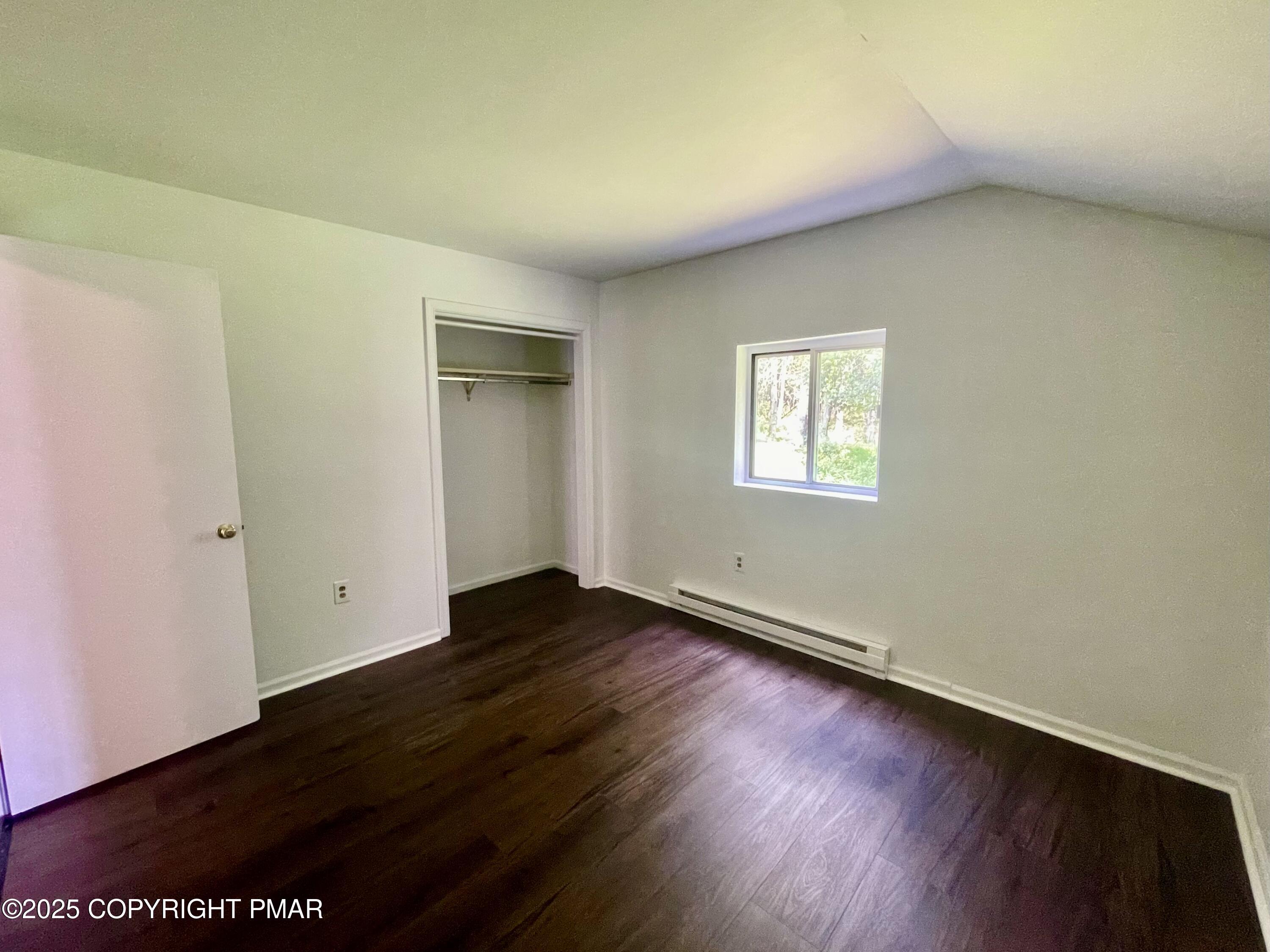 3284 Highway 115, Unit 4 Effort, PA 18330 - Photo 2 of 8 an empty room with wooden floor and windows