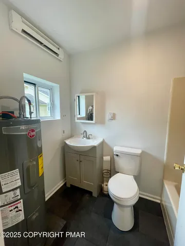 a white toilet sitting next to a bathroom sink