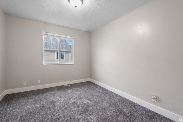 273 West 1010th Street South Logan, UT 84321 - Photo 15 of 19 Spare room with carpet and a textured ceiling