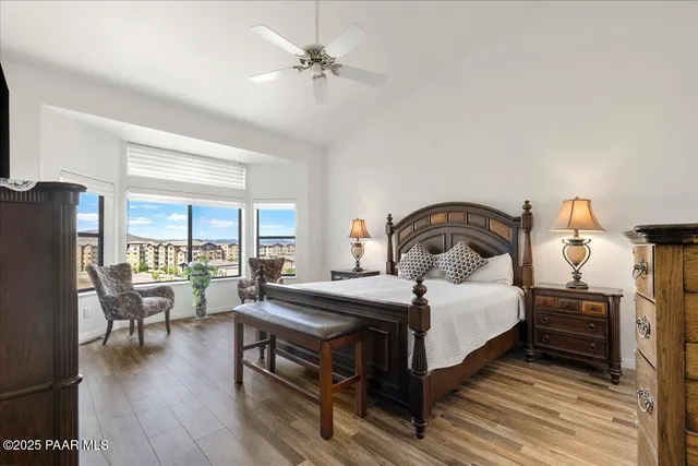 a bedroom with a bed and a large window