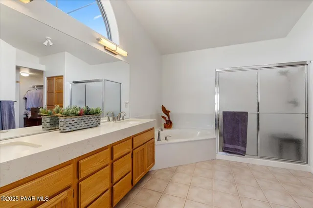 a spacious bathroom with a tub sink and mirror