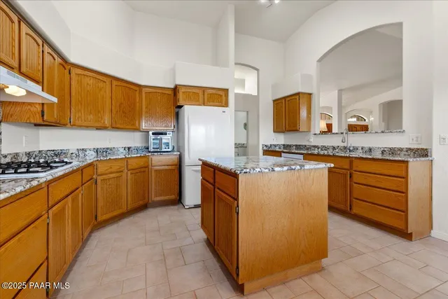 a kitchen with stainless steel appliances granite countertop a stove and a refrigerator