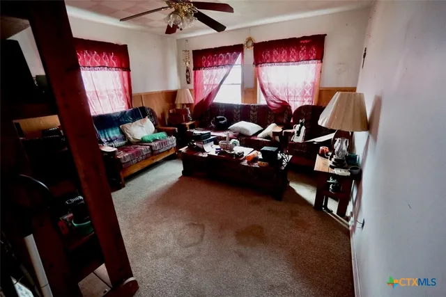 a living room with furniture and a book shelf