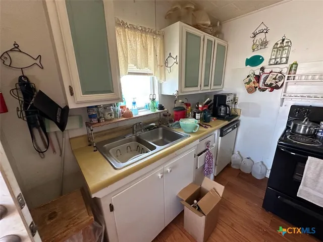 a kitchen with sink refrigerator and window