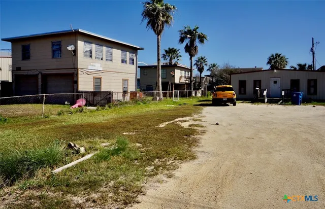 a view of a house with backyard and sitting area